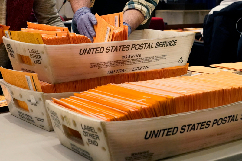 Wahlbeamte sortieren Briefwahl- und vorgezogene Stimmzettel für das Zählen im Rathaus von Boston am Montag, dem 2. November 2020, in Boston. (AP Foto / Elise Amendola)